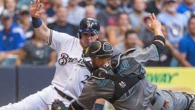 Milwaukee Brewers' Scooter Gennett is tagged out by Arizona Diamondbacks' Welington Castillo during the first inning of a baseball game Tuesday, July 26, 2016, in Milwaukee.