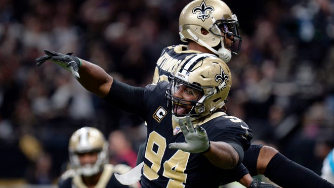 FILE - In this Jan. 7, 2018, file photo, New Orleans Saints defensive end Cameron Jordan (94) celebrates a defensive stop in the second half of an NFL football game against the Carolina Panthers, in New Orleans. Newly named All-Pro for the first time, Saints defensive Cam Jordan takes his playful yet menacing presence this weekend to the city where his father became a Pro Bowl tight end.  (AP Photo/Bill Feig, File)