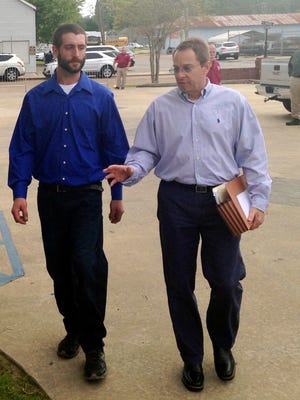 Christopher Few, left, walks with attorney Mark Jeansonne to the courthouse in Marksville, La., Tuesday, March 21, 2017. Derrick Stafford, a Louisiana law enforcement officer, is charged with murder in the shooting death of Few's 6-year-old autistic. Few was also wounded in the shooting.