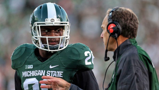 Michigan State Spartans head coach Mark Dantonio talks to Michigan State Spartans safety RJ Williamson (26) during the 2nd half of a game at Spartan Stadium.  MSU won 35-11.