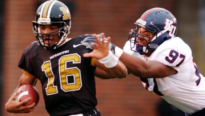 Missouri quarterback Brad Smith, left, is sacked by Kansas' Jermial Ashley, right, Saturday, Nov. 20, 2004, during the first half in Columbia, Mo. (AP Photo/L.G. Patterson)