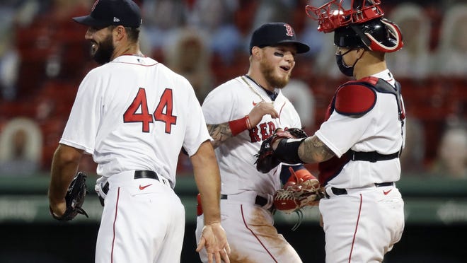 Boston Red Sox's Alex Verdugo, center, celebrates with Brandon Workman (44) and Christian Vazquez after the Red Sox defeated the Toronto Blue Jays during a baseball game, Friday, Aug. 7, 2020, in Boston.