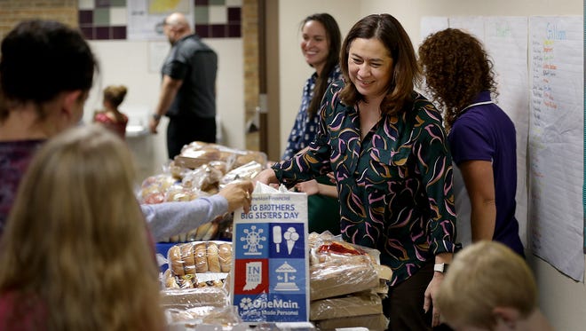Gannett Indiana's Patricia Miller helps families at the Stout Field Elementary's food pantry. Stout Field Elementary has become the second school in Wayne Township to open a food pantry to serve kids and their families. 90 percent of the students qualify for free or reduced lunch. 