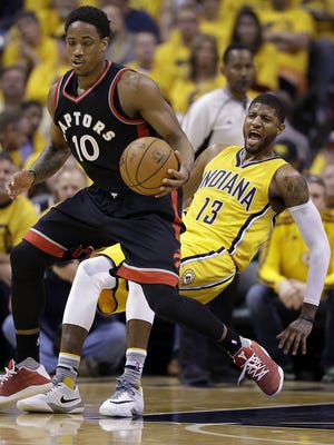 Indiana Pacers forward Paul George (13) draws a charge from Toronto Raptors guard DeMar DeRozan (10)in the first half of their Eastern Conference first round playoff game Thursday, April 21, 2016, evening at Bankers Life Fieldhouse.