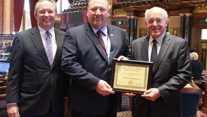 Foundation Executive Director Jerry Fleagle and trustee president Robert Downer, present the Hoover Uncommon Public Service Award in the Iowa Senate chamber to State Senator Tim Kapucian, R-Keystone.