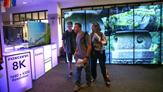 Students looks at displays of Foxconn technology at Marquette University in October 2017.