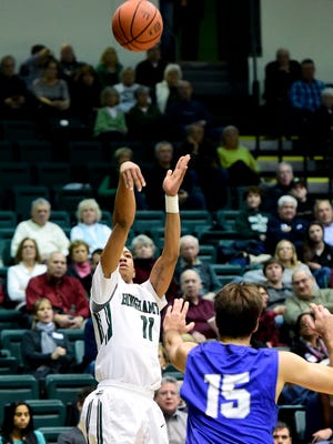 Binghamton University’s Romello Walker hits a three-pointer while being covered by Hartwick’s Joe Krong during a men's basketball game at the Events Center on Wednesday.