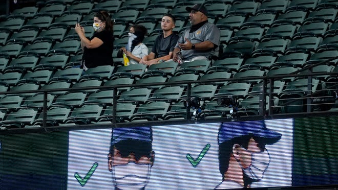 Fans watch during batting practice before Game 1 of a baseball National League Championship Series between the Los Angeles Dodgers and the Atlanta Braves Monday, Oct. 12, 2020, in Arlington, Texas.