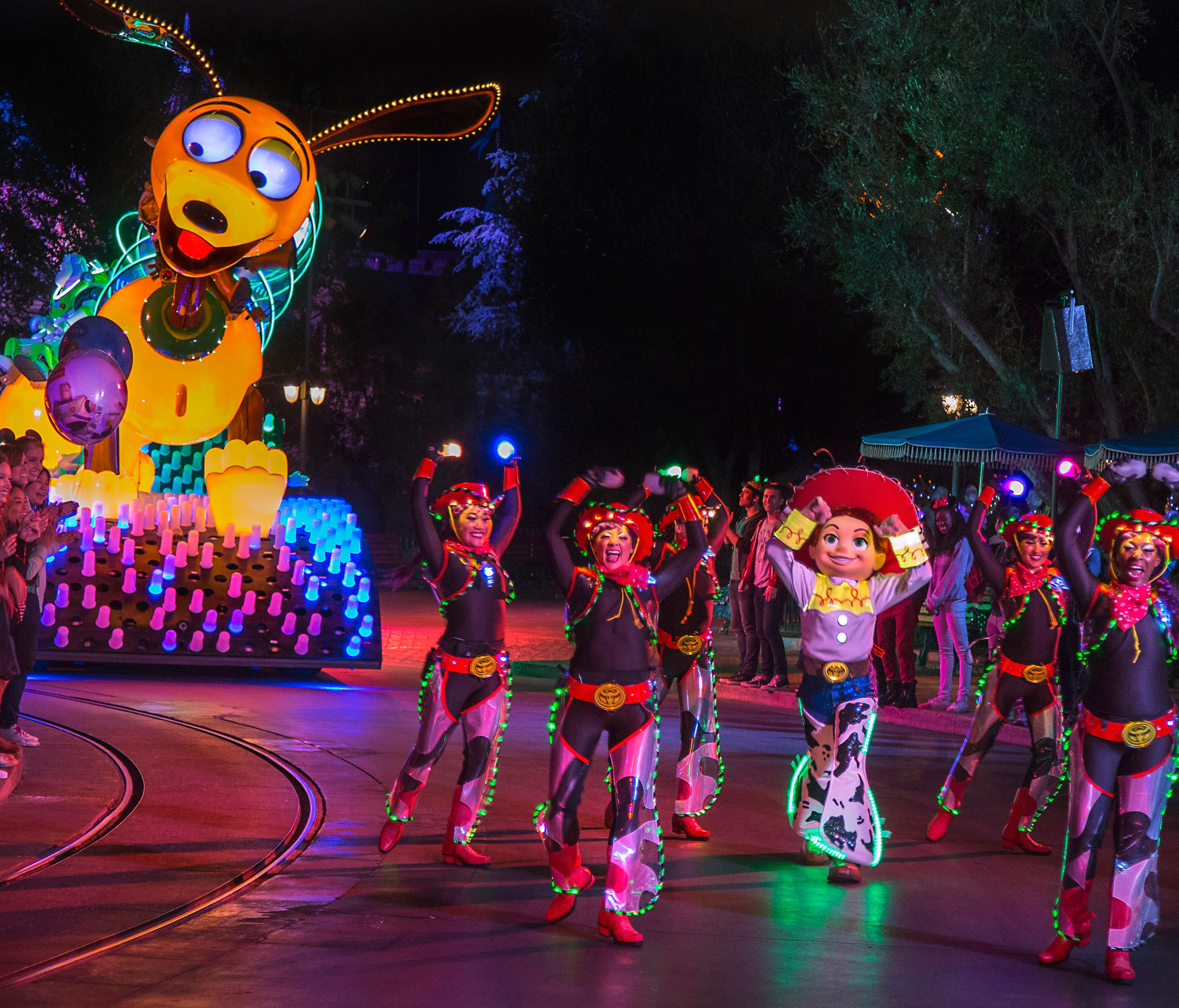 'PAINT THE NIGHT'  PARADE (ANAHEIM, Calif.)— Jessie from the Disney•Pixar 'Toy Story' films appears with parade performers in synchronized, LED costumes in this after-dark spectacular inspired by the iconic 'Main Street Electrical Parade.' 'Paint the