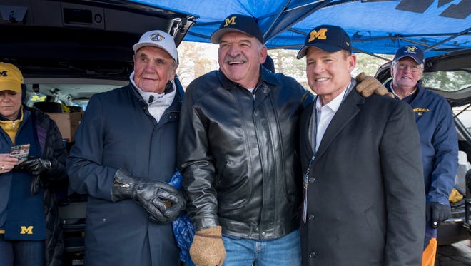 From left, Michigan native Dick Enberg and UM radio man Dan Dierdorf pose for a photo with Les Miles, former Michigan football player and former head coach at LSU before Saturday's game.