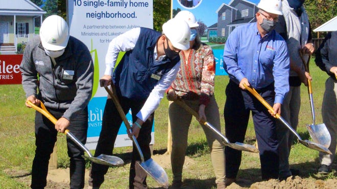 Members of the Holland City Council and nonprofit organizations Jubilee Ministries and Lakeshore Habitat for Humanity throw the first shovelfuls of dirt at a groundbreaking ceremony Wednesday, Oct. 7, for a housing project that is a collaborative effort of the two nonprofits.