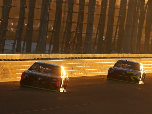 Martin Truex Jr. (78) and Kyle Busch (18) race during
