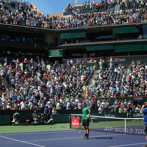 Roger Federer about to hit autographed tennis ball