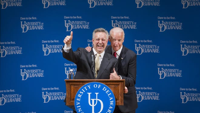 Former Vice President Joe Biden jokes with University of Delaware President Dr. Dennis Assanis as he grabs him by the shoulder during the ceremonial opening of the new Biden Institute at the University of Delaware's Roselle Center for the Arts in Newark in March 2017.
