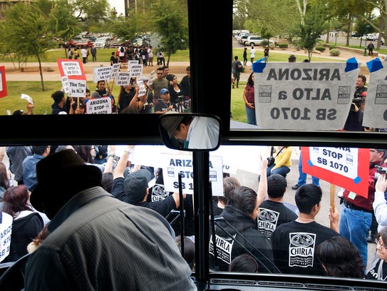 Opponents of SB 1070 arrive by bus from California