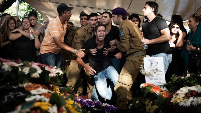 The brother of Israel Defense Forces Sgt. Daniel Kedmi reacts during his funeral.