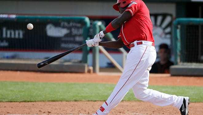 Cincinnati Reds Aristides Aquino hits a triple in the bottom of the eighth inning of the MLB Spring Training game between the Cincinnati Reds and the San Francisco Giants at Goodyear Ballpark in Goodyear, Ariz., on Friday, March 4, 2016.  The Reds suffered their first loss of the preseason, 4-3.