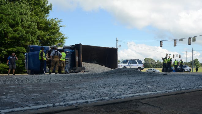A truck carrying gravel overturned at the intersection of Vann Drive and Highland Avenue in Jackson, Tenn., on Thursday, Aug. 11, 2016.