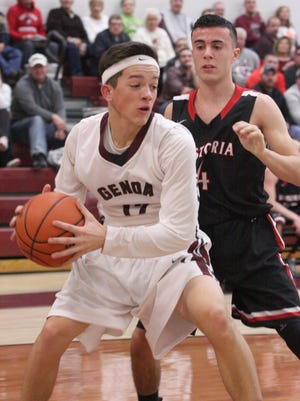 Genoa's Sam Sutter looks for a teammate Tuesday against Fostoria.