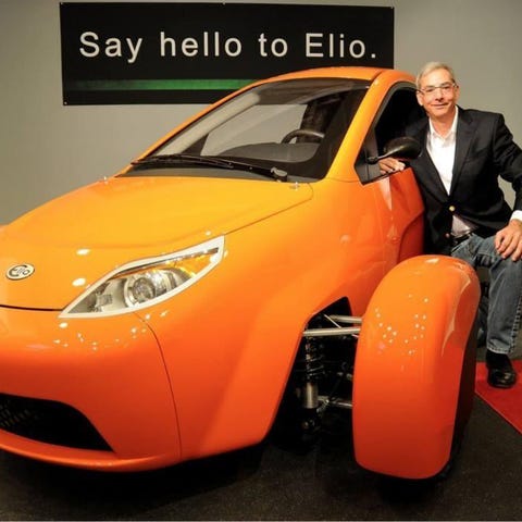 Paul Elio poses with his three-wheel vehicle, the 