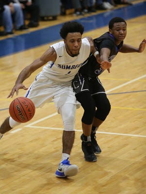 Sayreville's Xavier Townes (1) drives to the basket against Carteret's Kahir Raymond during their GMC Tournament quarterfinal on Sunday in New Brunswick.