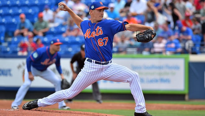 New York Mets relief pitcher Seth Lugo (67) delivers a pitch against the Washington Nationals during a spring training game at First Data Field.