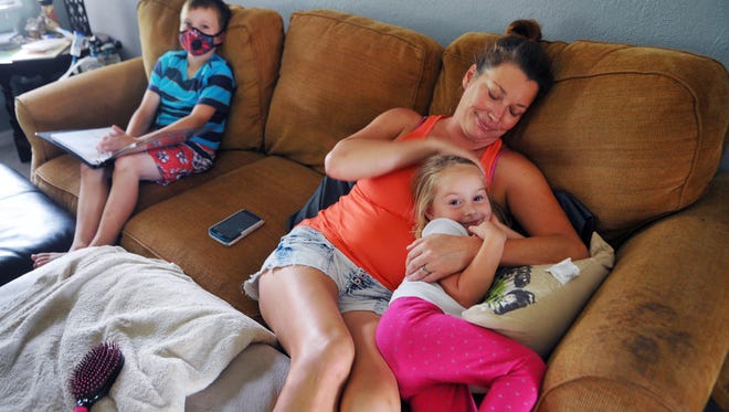 Shannon Owens, with her son, Tanner Owens, 10, and daughter, Tayler Owens, 3, waits in her Port St John home for her power to be restored. She got power back around 1 p.m. Tuesday, about 4 days and 9 hours after it went out because of Hurricane Matthew.