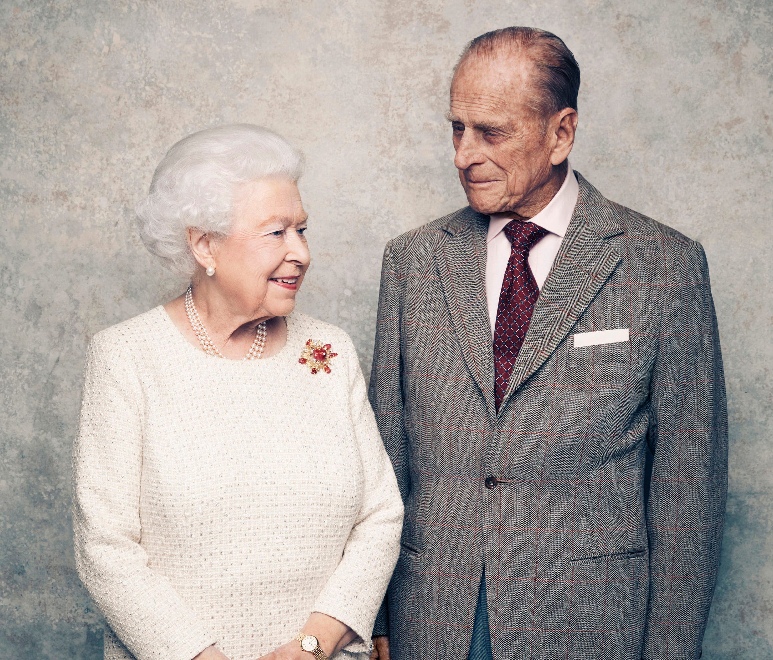In this handout photo issued by Camera Press and taken in Nov. 2017, Britain's Queen Elizabeth and Prince Philip pose for a photograph in the White Drawing Room pictured against a platinum-textured backdrop at Windsor Castle, England.