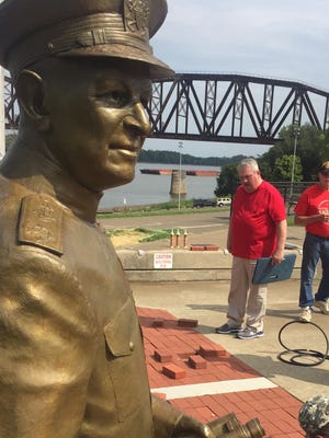 Volunteers with the Henderson War Memorial Foundation install 21 memorial bricks around the Admiral Husband E. Kimmel statue on the Henderson Riverfront Wednesday morning. In front is Jeff Oliver and behind him, from left, are Ken Christopher, Jim Hanley and Bob Bean. Not shown, but also pitching in, was Jim Davis. Christopher said they were installing new bricks, and replacing some that had errors from the first installation. Anyone interested in sponsoring a brick as part of the ongoing program can find more information at hendersonwarmemorial.org