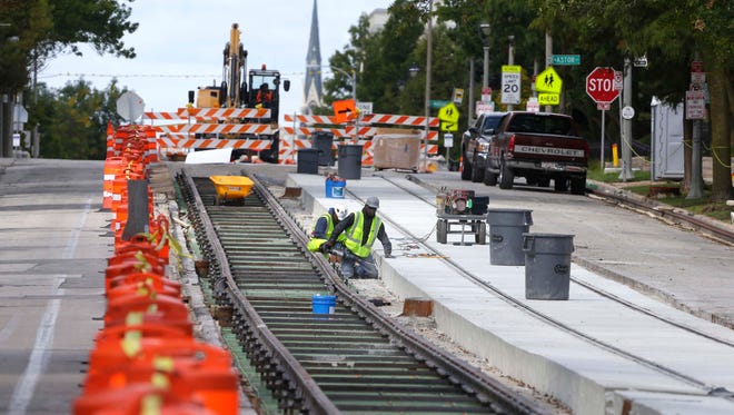 Workers prepare tracks on Ogden Ave. near Farwell Ave. as work continues on the Milwaukee Streetcar project. There is one lane of traffic eastbound from Jackson St. to Prospect Ave. There is no through traffic on Ogden Ave. at Jackson St.