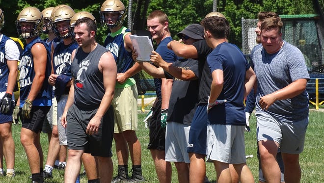 Former Lancaster standout Luke Sheridan looks at a play that his former teammates were ready to run against the current members of the Gales' football team during a 7-on-7 drills.
