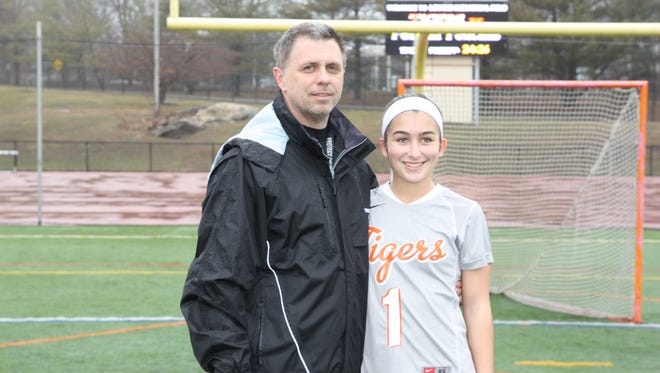White Plains girls lacrosse head coach Mike Leone, pictured here with former varsity player Erin McGee, passed away on Thursday, April 7th, 2016. He was 49 years old.