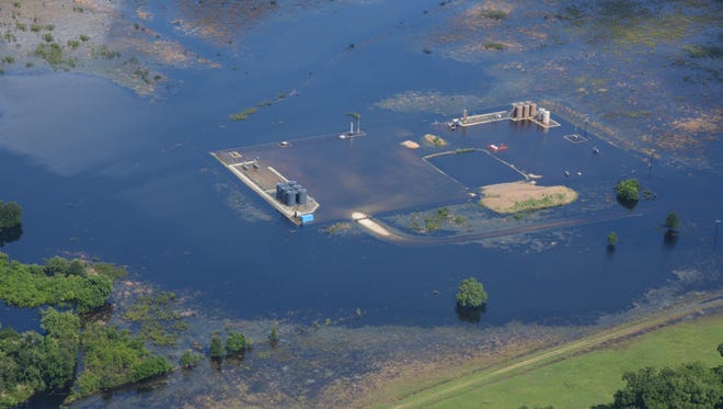 Floodwaters inundate an energy production site on the Trinity River in June 2015.