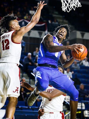 University of Memphis guard Kareem Brewton Jr. (right) drives for a layup against University of Alabama defender Dazon Ingram (left) during first half action at the Veterans Classic  in Annapolis, Md., Friday, November 10, 2017.