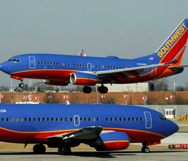A Southwest Airlines Boeing 737 waits to take off at Chicago's Midway Airport as another lands on Feb. 9, 2012.