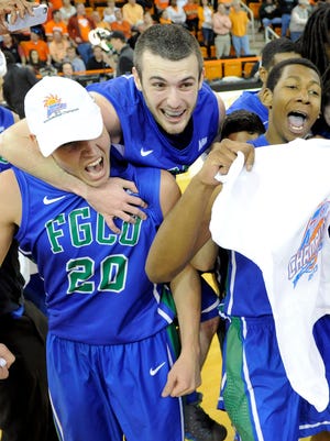 Florida Gulf Coast Eagles forward Chase Fieler, guard Brett Comer, and forward Eric McKnight celebrate their 88-75 victory over the Mercer Bears in the championship game of the Atlantic Sun tournament last season.