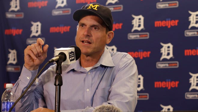 Michigan coach Jim Harbaugh  talks to the media before throwing  out the first pitch prior to the start of the game between the Detroit Tigers and the Pittsburgh Pirates on Tuesday, June 30, 2015.