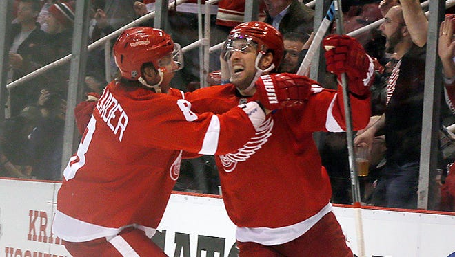Detroit Red Wings' Riley Sheahan, right, celebrates his third-period goal against the Tampa Bay Lightning with Justin Abdelkader in Game 3 of the first round of the Stanley Cup Playoffs, Tuesday, April 21, 2015 at Joe Louis Arena.