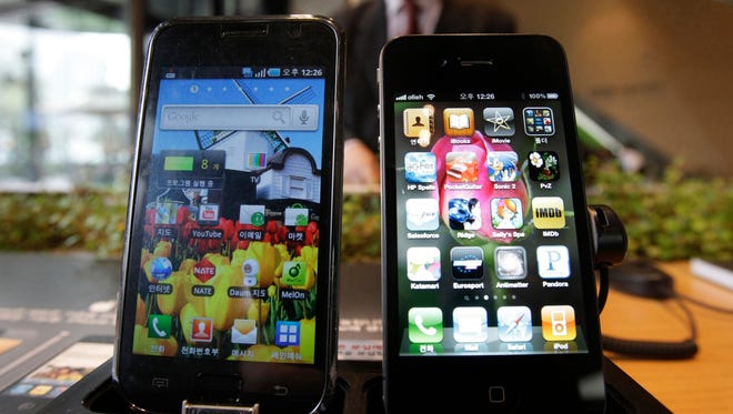 Samsung Electronics' Galaxy S, left, and Apple's iPhone 4 are displayed at the headquarters of South Korean mobile carrier KT in Seoul, South Korea.