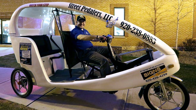 Kevin Otte sits in his new bike rickshaw that he plans on using to cart people around Fond du Lac events. March 8, 2016.