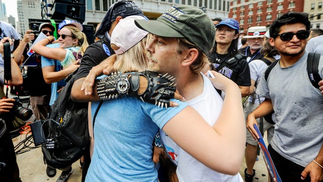 Bernie supporter Steven Saxton of Ohio hugs a Clinton supporter after the two had a heated exchange during a rally outside City Hall in Philadelphia, Wednesday July 27, 2016. John A. Pavoncello photo