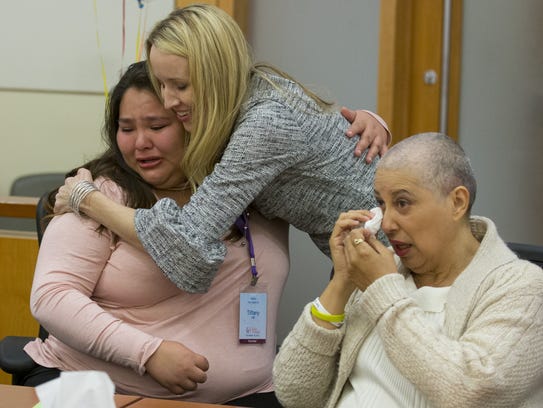 Daliah Martinez, 16, (left) gets a hug from adoption