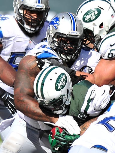 Lions C.J. Mosley stops Jets running back Chris Johnson during the third quarter.