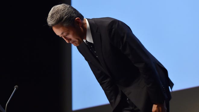 Japan's electronics giant Sony president Kazuo Hirai bows his head as he announces the company will slash the company's staff count by 15% at a news conference at Sony's headquarters in Tokyo on Wednesday.