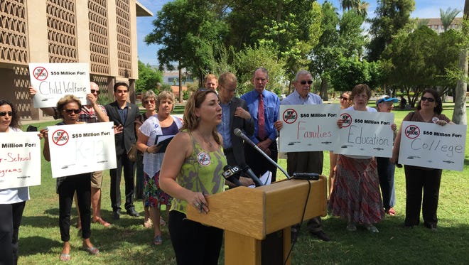 Caroline Isaacs of the American Friends Service Committee - Arizona speaks at rally Monday on the Capitol lawn calling on Gov. Doug Ducey to cancel the application process for another 2,000 private prison beds.