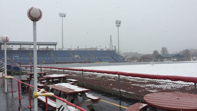 Snow covers the outfield grass while the tarp remains over the infield at NYSEG Stadium on Saturday morning, April 9, 2016.