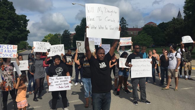 Brandon Allen, center, a Purdue graduate student, leads a group to block State Street on July 8 in a Black Lives Matter rally.