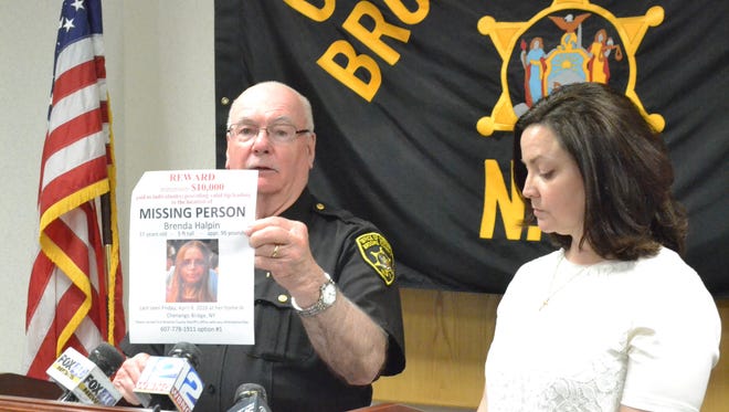 Broome County Sheriff David Harder holds a sign for missing 37-year-old Chenango Bridge resident Brenda Halpin at a news conference in May. Brenda's sister, Endicott resident Susan Papathomopoulos, is at right.