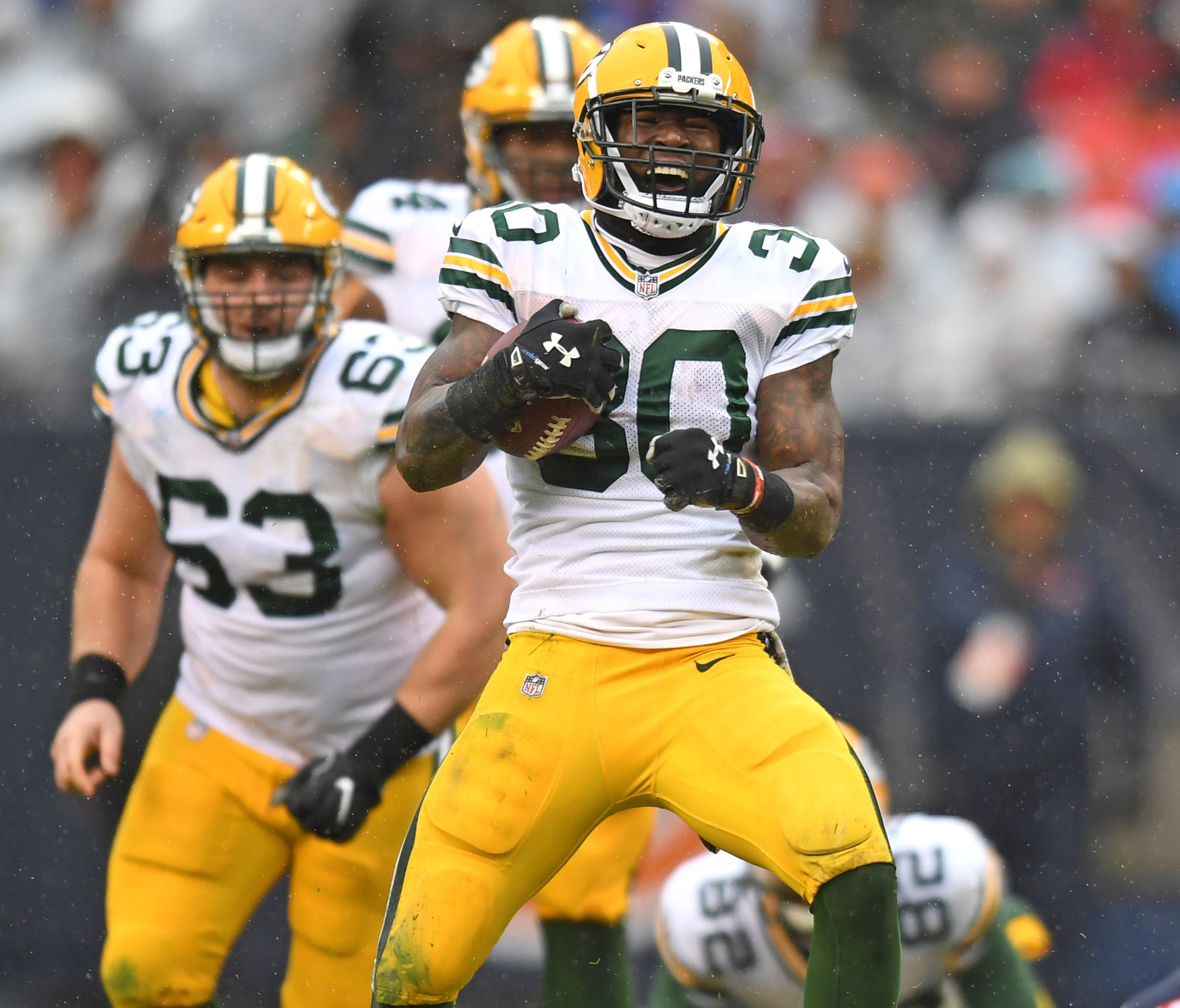 Green Bay Packers running back Jamaal Williams (30) celebrates after gaining yardage during the second half against the Chicago Bears at Soldier Field.