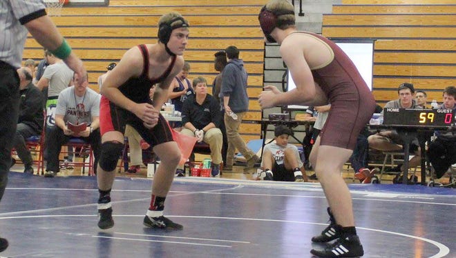 Fairview Middle’s Ethan Stewart (left) competes on the wrestling mat.